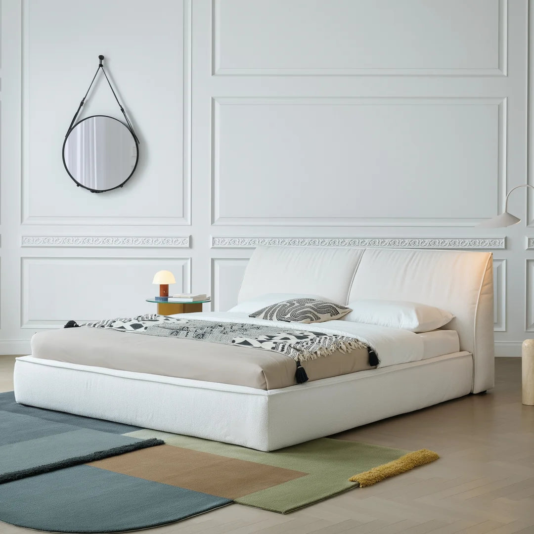 Modern minimalist bedroom featuring a light beige custom bed frame slipcover.