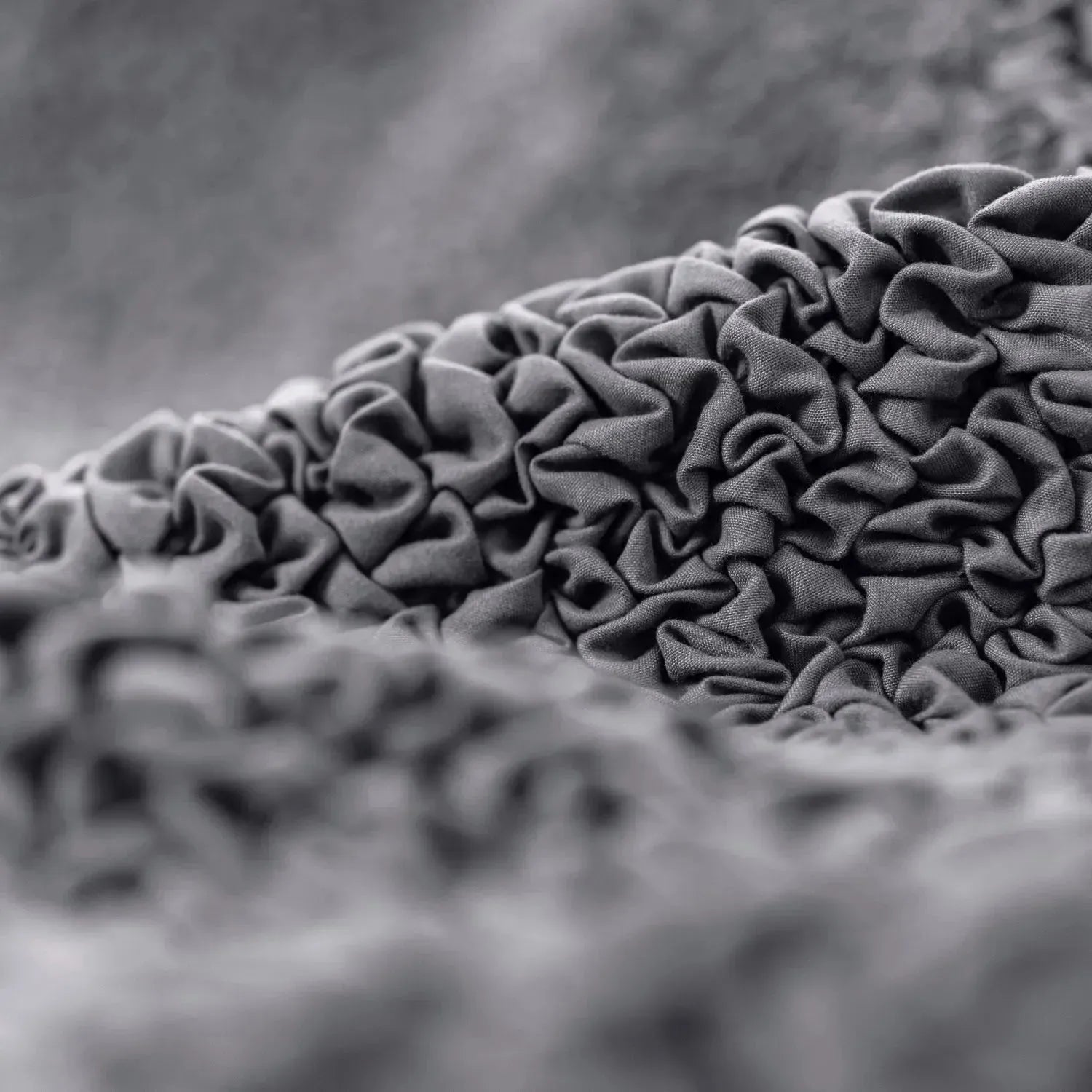 Close-up of Plume Bubble light gray slipcover fabric showing soft, stretchable texture
