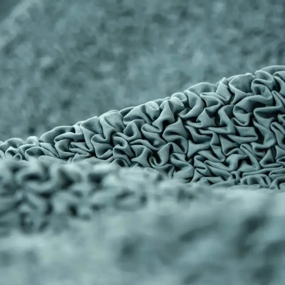 Close-up of sage green slipcover fabric from Plume Bubble showing soft, smooth weave