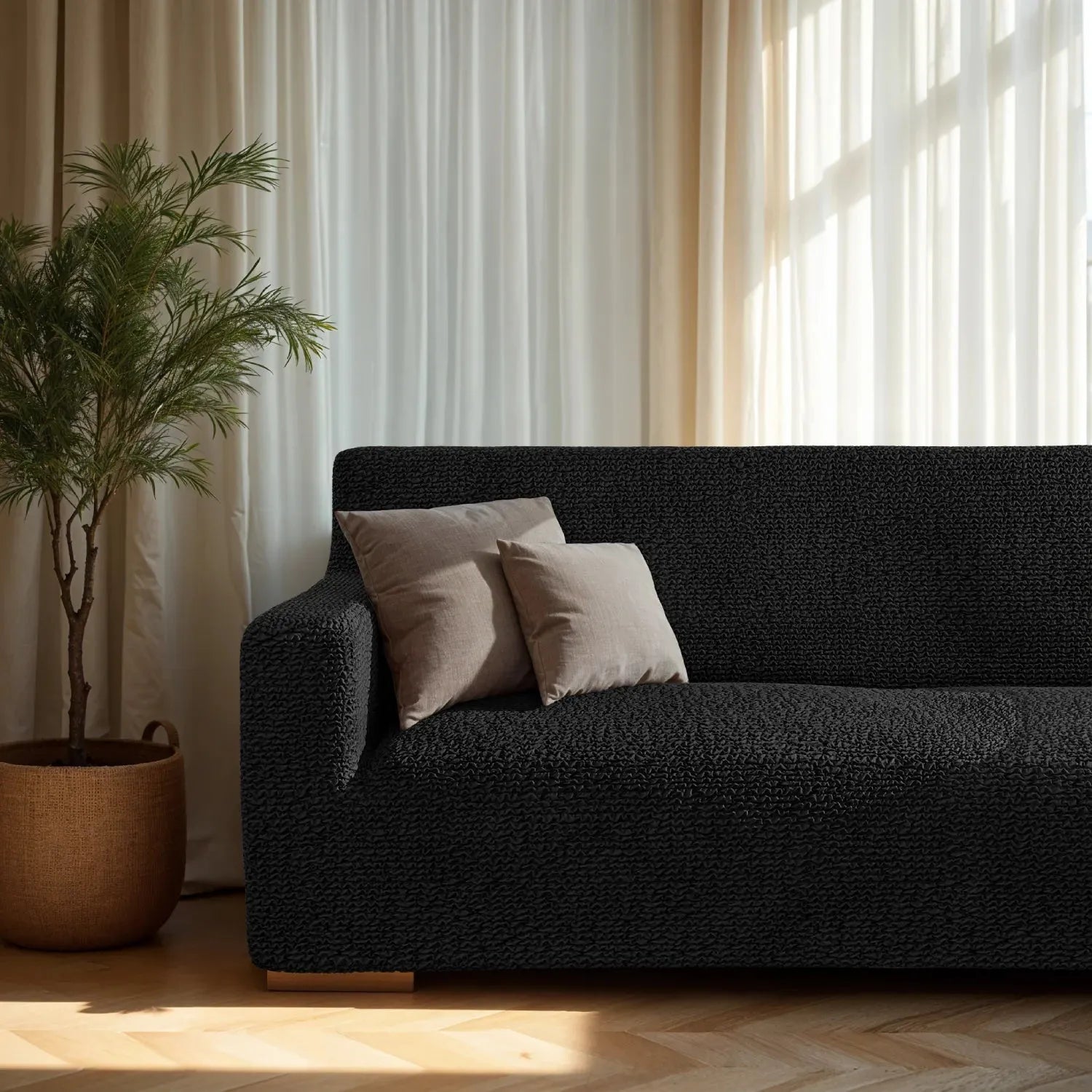 Plume Bubble black couch cover styled in a minimalist living room
