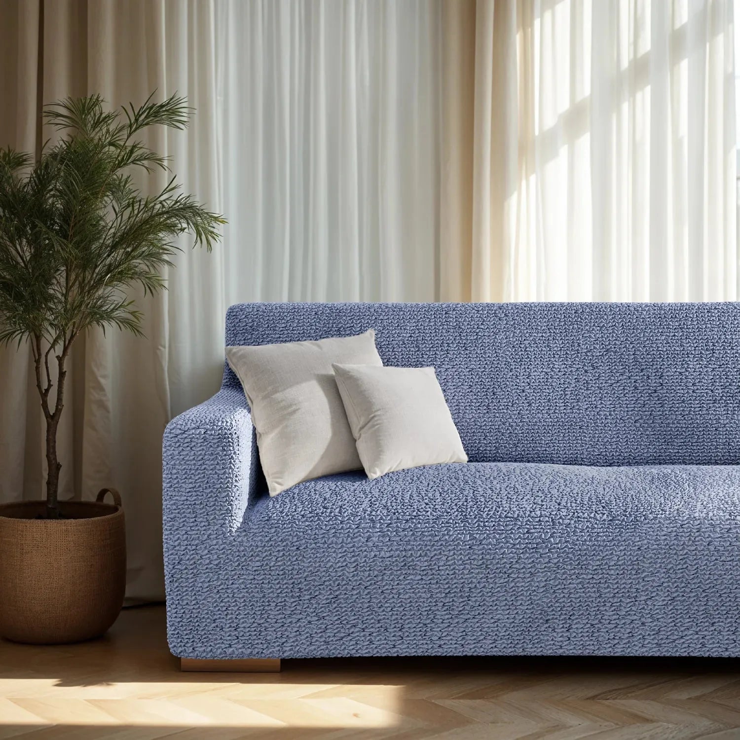 Blue sofa slipcover by Plume Bubble with a soft, modern appeal