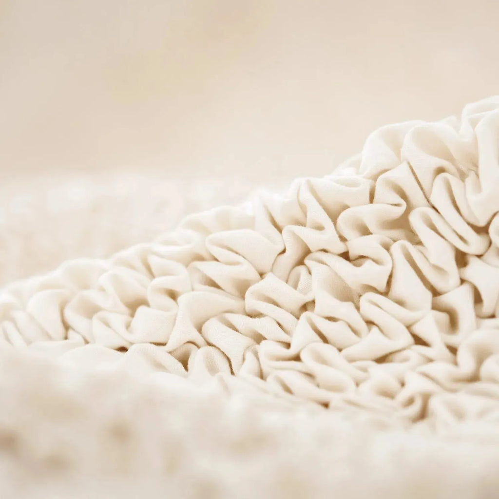 Cream sofa slipcover by Plume Bubble with a clean, soft finish