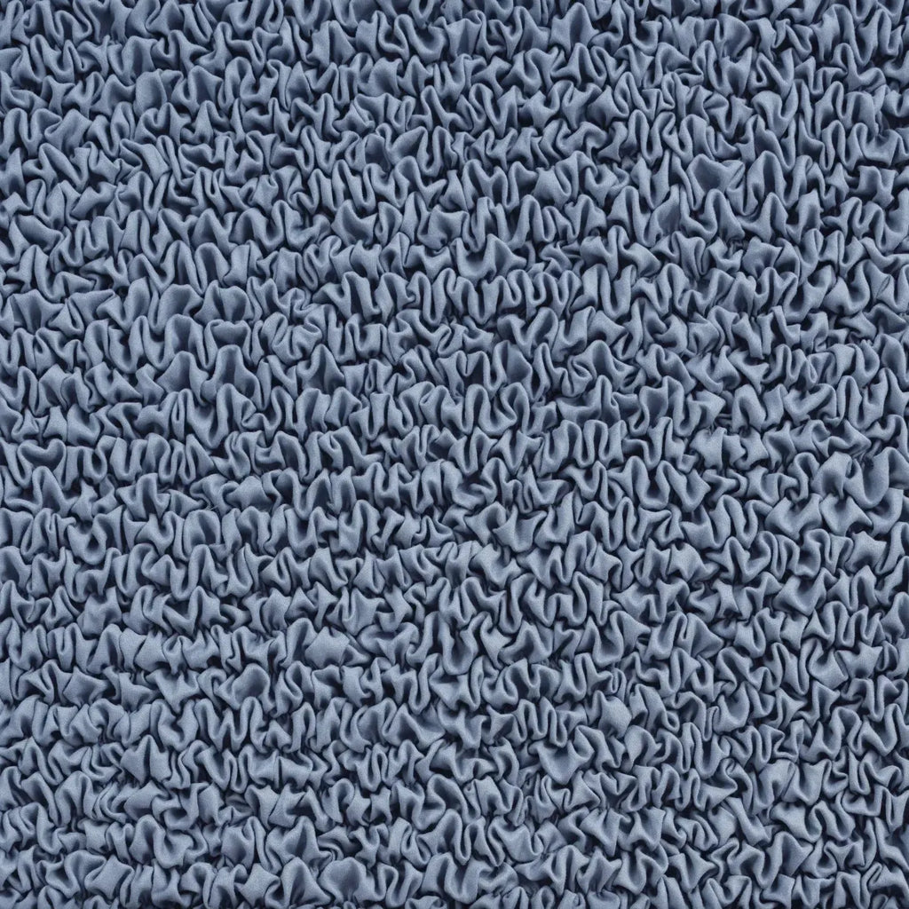 Close-up of light blue slipcover fabric from Plume Bubble showing stretch and softness