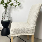 Soft white custom dining chair cover by Plume Bubble – breathable, snug fit for cozy and stylish home interiors.