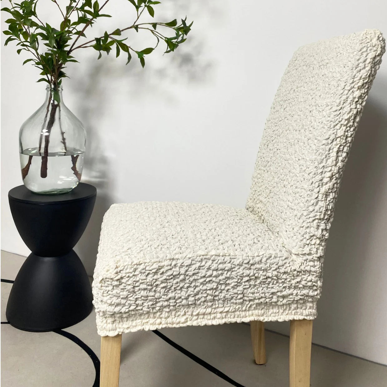 Soft white custom dining chair cover by Plume Bubble – breathable, snug fit for cozy and stylish home interiors.